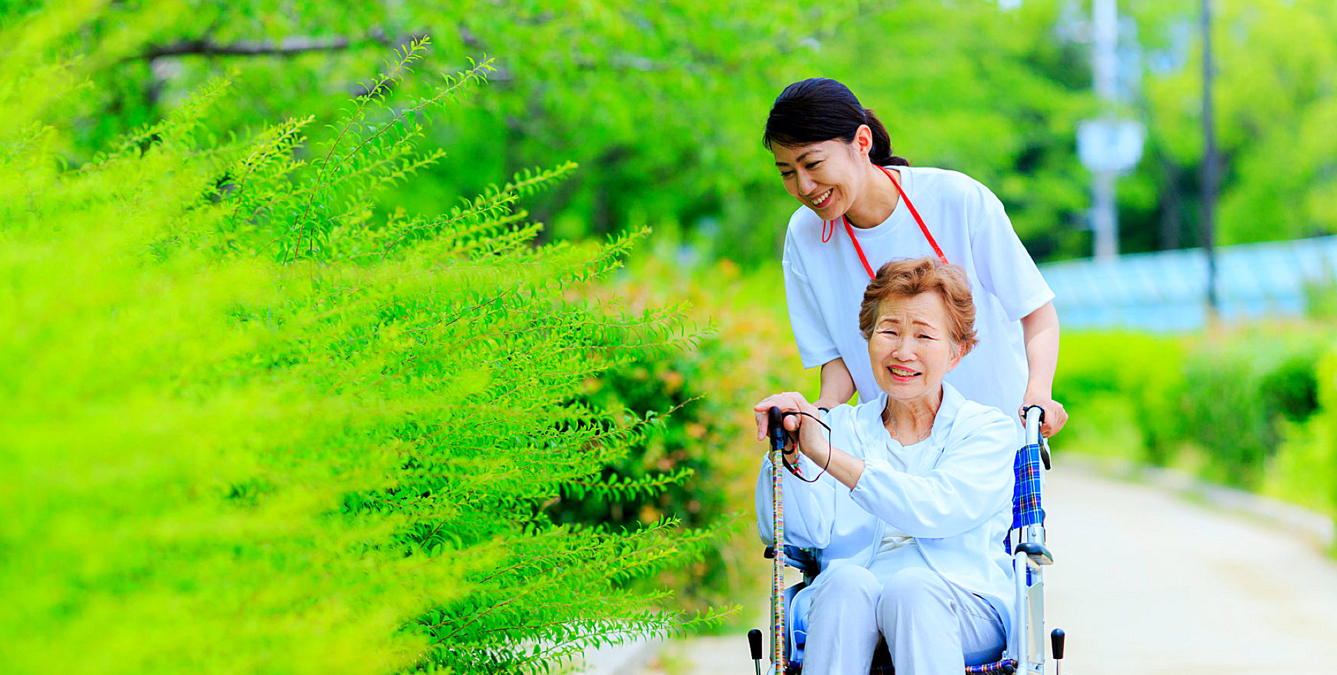 caregiver and her senior patient on a wheelchair